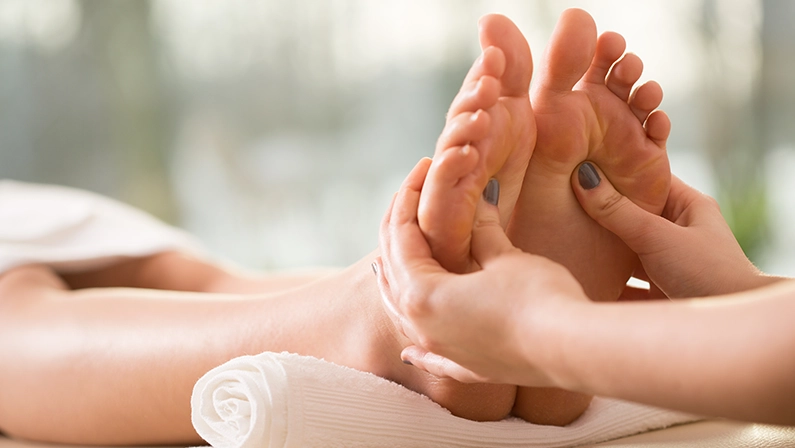 Close-up of young woman having reflexology