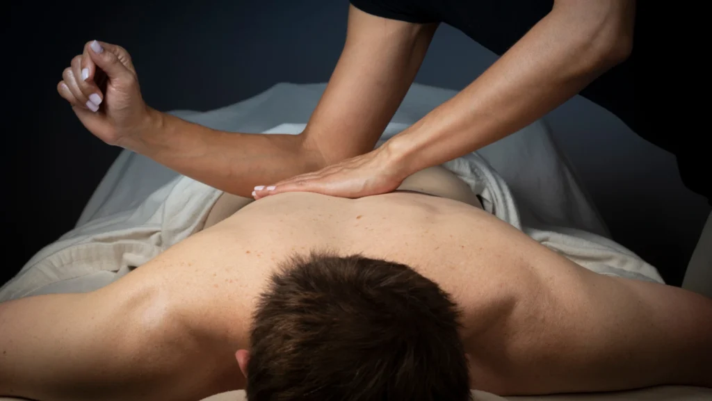 Therapist performing deep tissue massage therapy