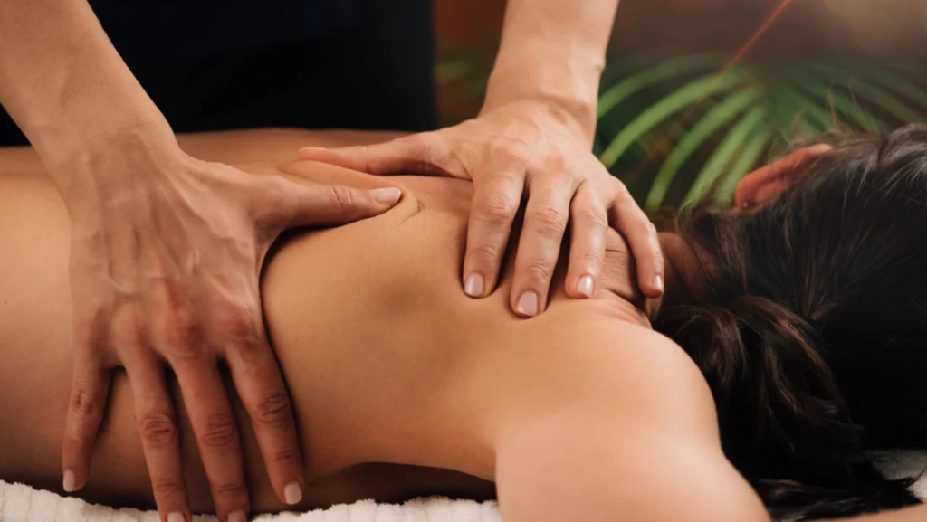 Deep tissue massage therapy. Therapists massage a woman's shoulder