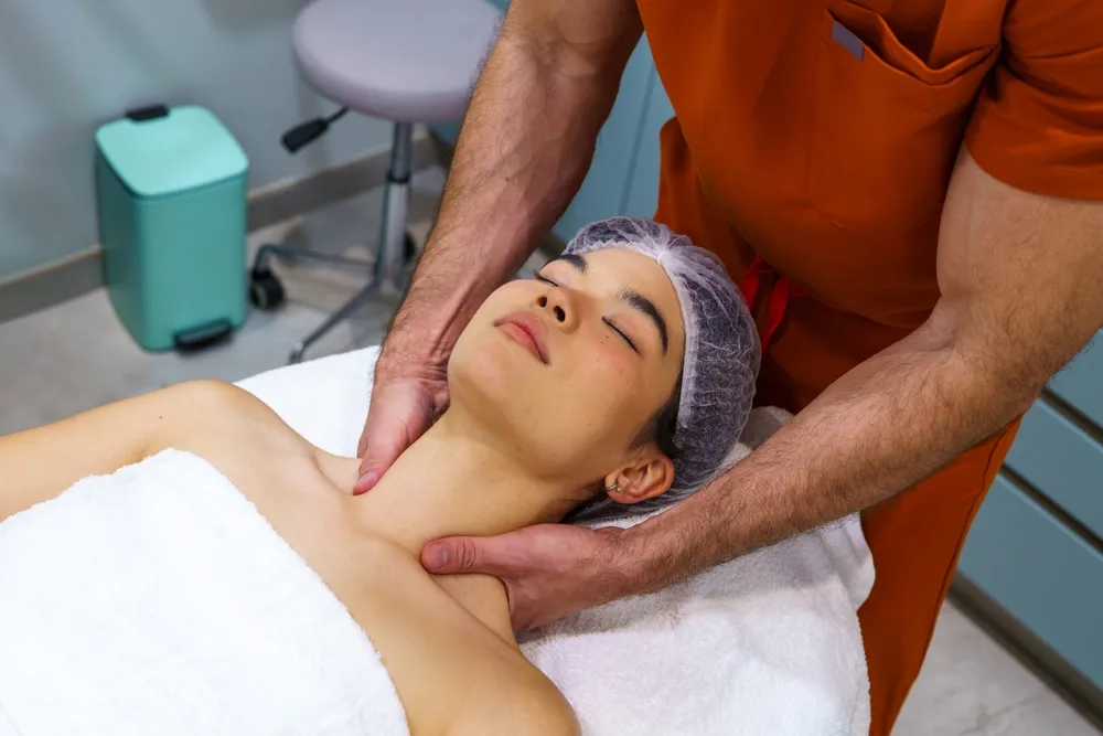 Healthcare professional providing a soothing neck massage to a female patient