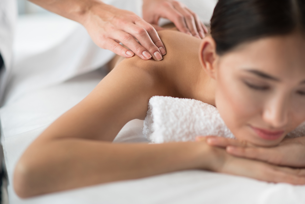 massaging female shoulder with gentleness