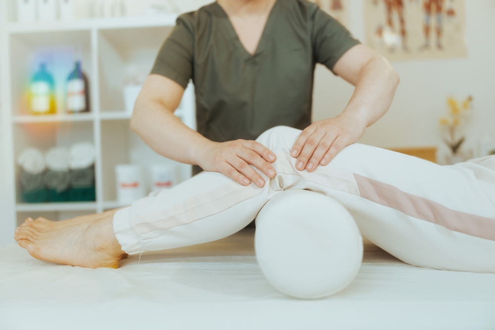 Healthcare time. Closeup on massage therapist woman in massage cabinet with client doing checkup.